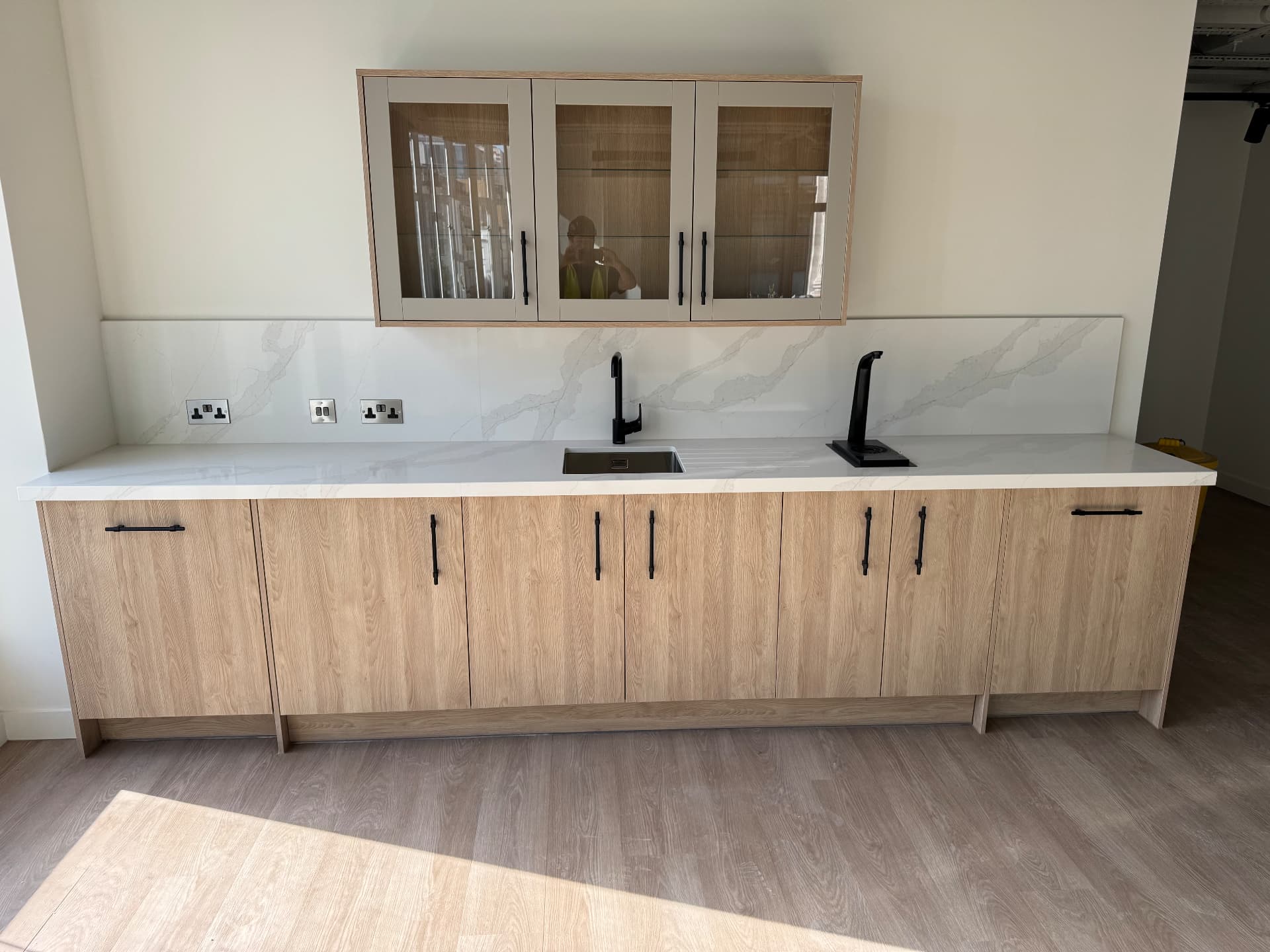 Tea point run in light oak veneer with quartz worktop